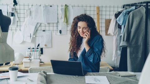 A small business owner working on her laptop in her shop