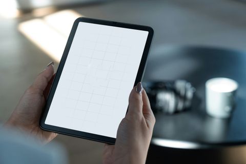 Hands holding a tablet running AI software